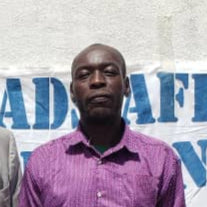 Two men standing in front of a Pridepad Africa banner.